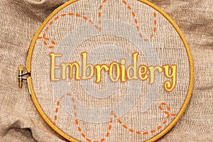 Embroidery hoop with natural linen fabric.