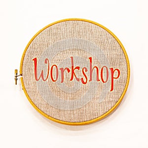 Embroidery hoop with natural linen fabric, with text.