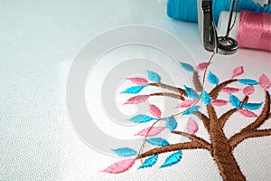 Embroidery machine and two threads on the background