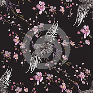 Embroidery oriental seamless pattern with cranes and cherry blossom.