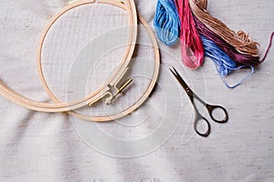 Embroidery set. White linen fabric, embroidery hoop, colorful threads and needls.