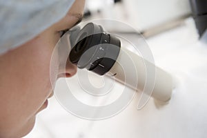 Embryologist adding sperm to eggs