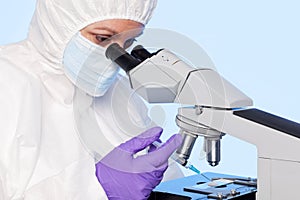 Embryologist extracting a sample using a syringe. photo