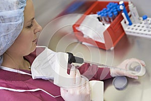 Embryologist processing sperm sample