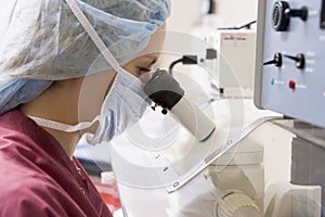 Embryologist using microscope photo