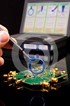 EMC engineer analyzing PCB using near-field probe