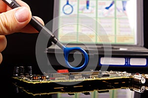 EMC engineer analyzing PCB using near-field probe