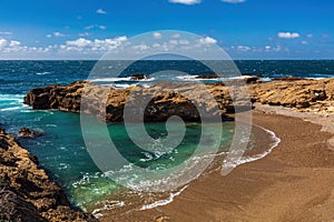 Emerald bay, Point Lobos Nature Preserve, Monterey. Green water with beach rocky cliff blue ocean and sky in background.