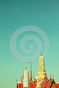 Emerald Buddha temple`s Pagoda roof under the moon in the morning