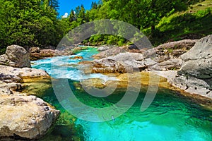 Emerald color Soca river with rocky shore, Bovec, Slovenia