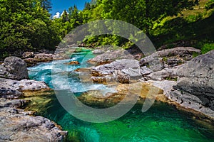 Emerald color Soca river with rocky shoreline, Bovec, Slovenia