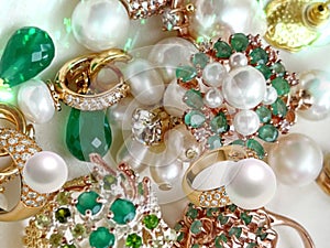 Emerald greeen white pearl gold rings and earing jewelry on white background