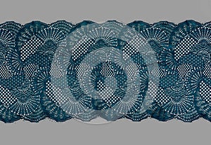 Color straight strip of lace fabric on a gray background. Elastic silk nylon braid border. use for clothes and linen decoration