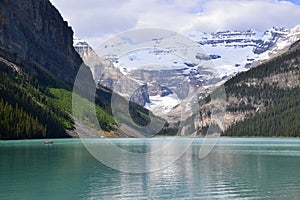 Emerald green water of Lake Louise and mountain reflections in Banff National Park