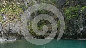 The emerald Lagoon is surrounded by sheer karst cliffs.