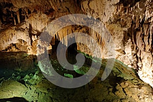 Emerald lake and stalactites in a cave in Slovakia