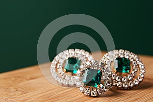 Emerald ring and pair of diamond earrings in gold