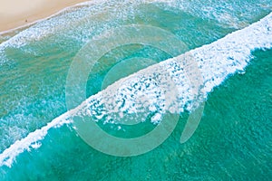 Emerald sea and small tourist lying on the sand beach at Surin beach, Phuket, Thailand