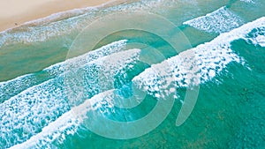 Emerald sea and small tourist lying on the sand beach at Surin beach, Phuket, Thailand