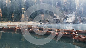 Emerald waters of Lago di Braies and wooden boats photo
