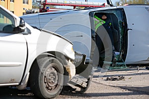 Emergency Responder Leaning into a Crashed Mini Van photo