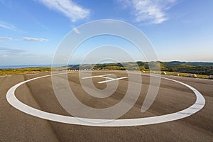 Empty helipad on top of a peak in a countryside remote location photo