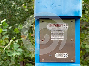 Emergency button, info button and speaker on a blue emergency post