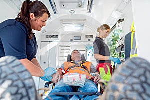 Emergency doctor in ambulance talking to injured man