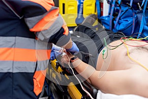 Emergency doctor checking pulse of a patient in the ambulance