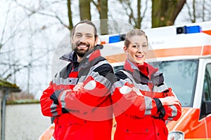 Emergency doctor in front of ambulance car