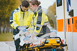 Emergency doctor giving oxygen to accident victim photo