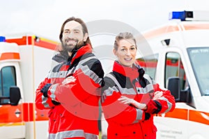 Emergency doctor and paramedic with ambulance