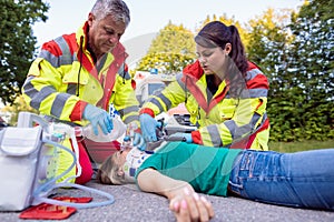 Emergency doctor ventilating injured woman after motorbike accident