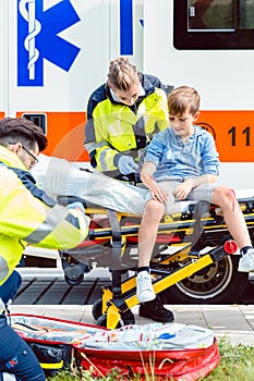 Emergency doctors caring for accident victim boy