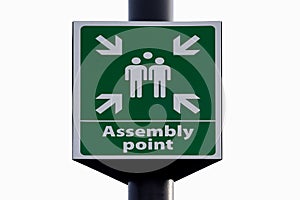 Emergency evacuation assembly point sign close up isolated against white background.