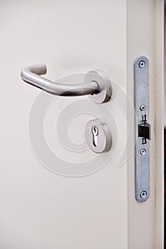 Emergency exit door, lock system and door handle