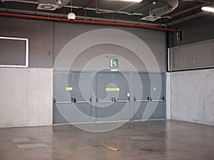 Emergency exit doors of a car parking space