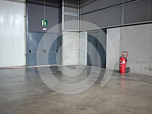 Emergency exit doors of an industrial area with a fire extinguisher
