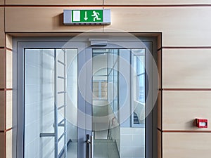 Emergency exit with glass door in airport office building. Emergency fire doors.