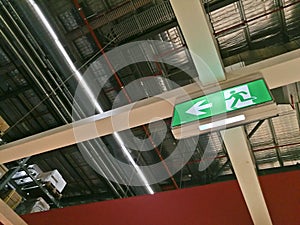 Emergency exit route sign on top of factory warehouse