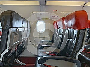 Emergency exit window in aircraft cabin. Long leg room seat. premium seat. Emergency exit seat.