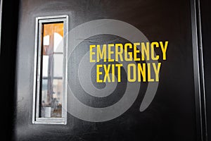 Emergency exit only yellow door sign