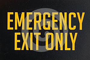 Emergency exit only yellow door sign