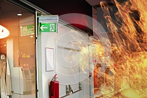 Emergency fire exit sign and fire in shopping mall