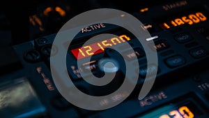 Emergency frequency selected active in the radio panel of modern jet airplane. Airliner cockpit details