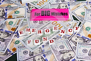 Emergency Fund: Close up scattered US Dollars with message on pink eraser for really big mistake and emergency fund.