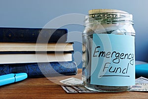 Emergency fund written on a jar with money