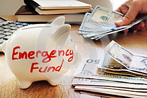 Emergency fund written on a piggy bank. photo