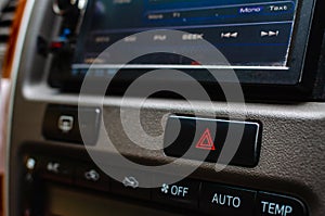 Emergency light botton at dashboard in a car.