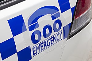 Emergency number 000 on a police car